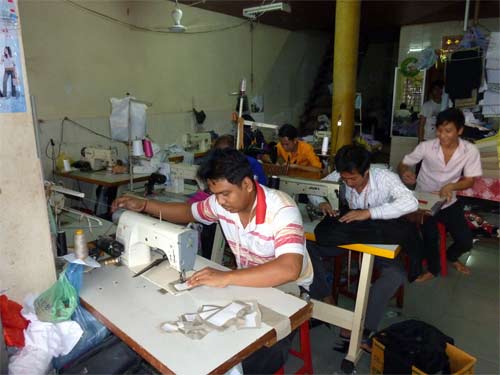 Men sewing in the market 